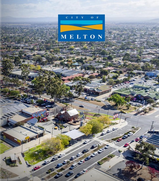 City of Melton | Investment Property Professionals Australia wide Aerial view of Melton city streets and buildings with a blue City of Melton logo at the top center.